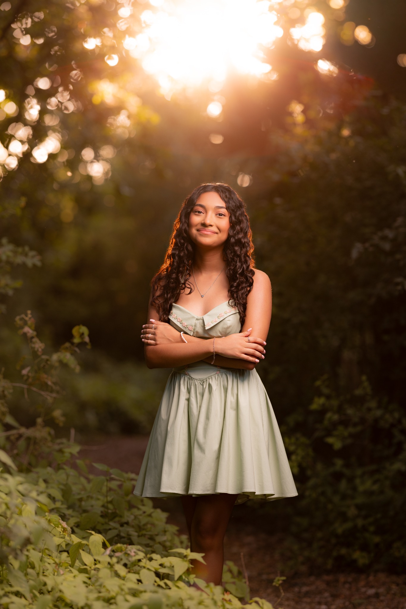 Camila standing in a forest