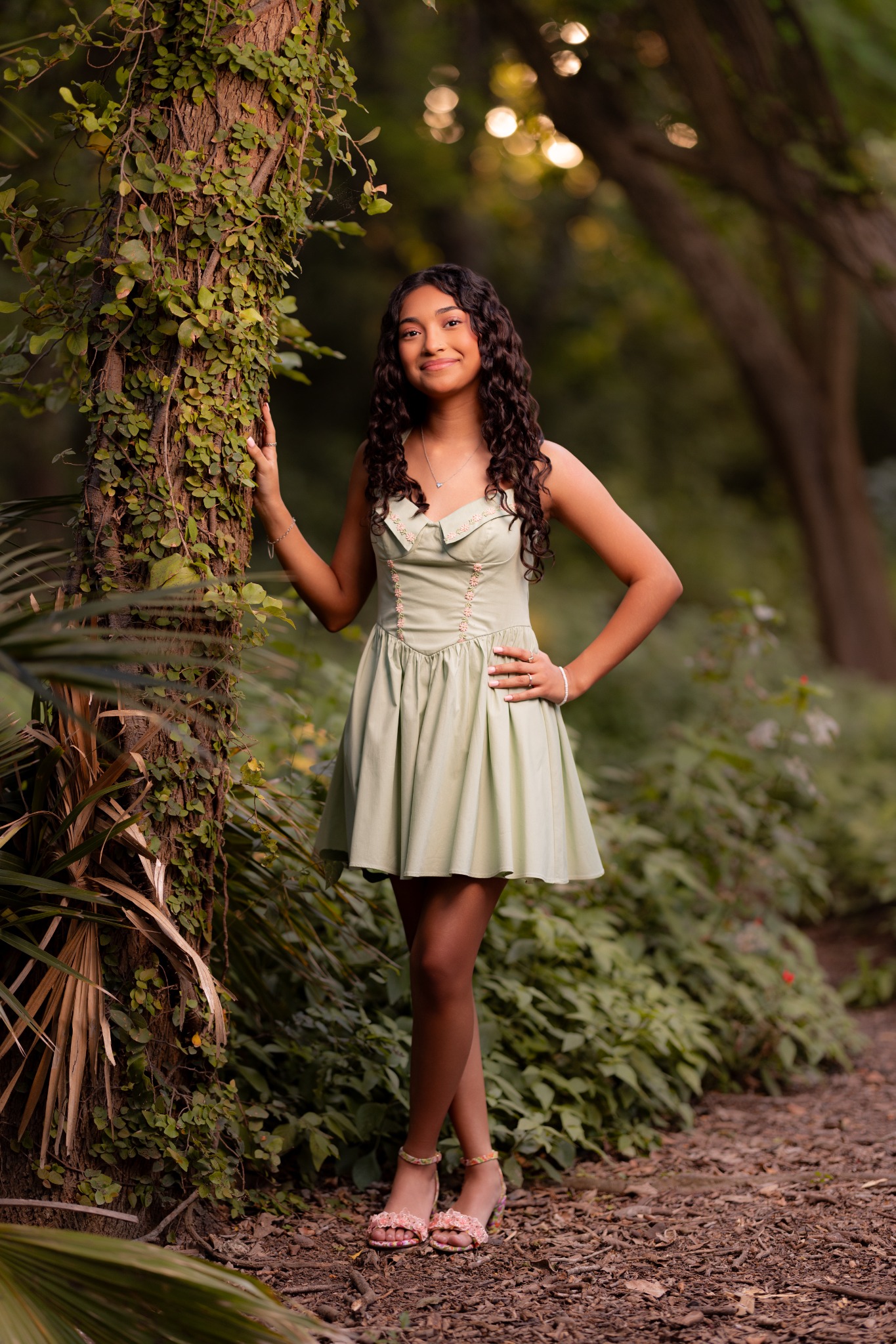 Camila beside a tree